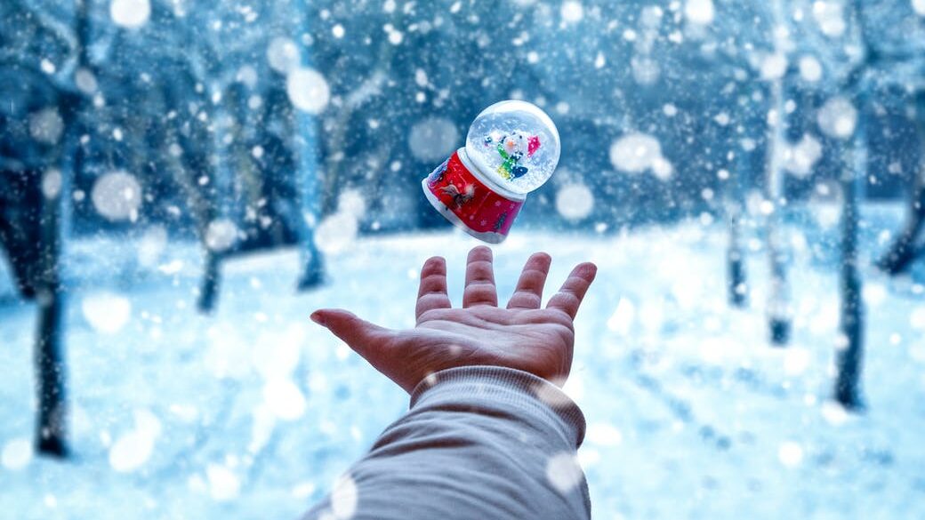person hand catching snow globe